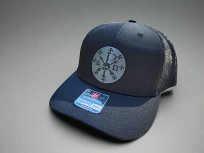 Black cap with a logo on a wooden surface outdoors