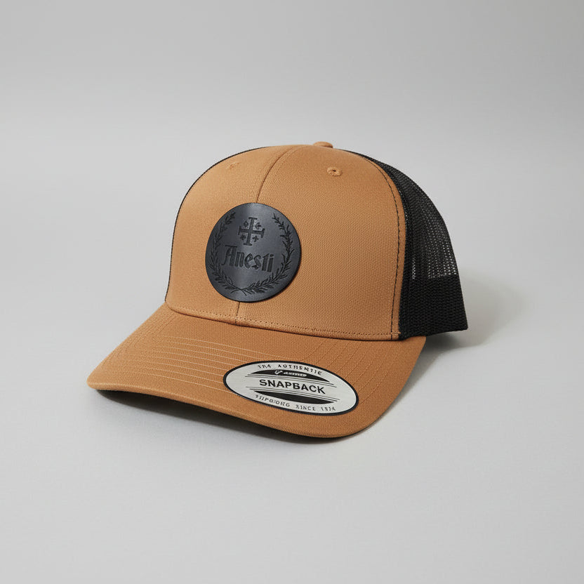 Anesti – Crest Leather Patch Trucker Cap