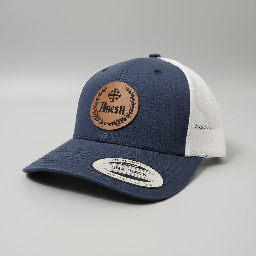 Anesti – Crest Leather Patch Trucker Cap