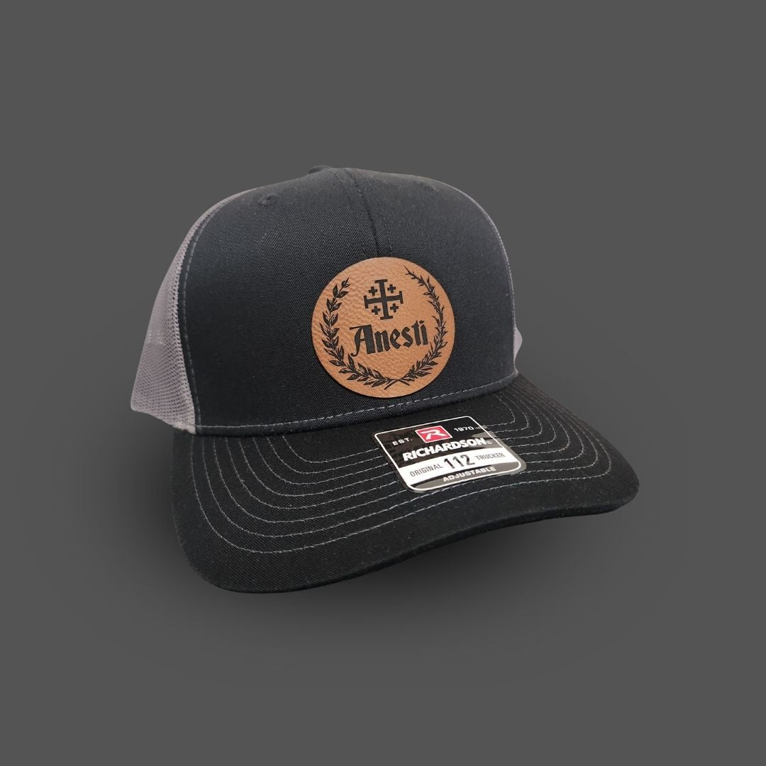 Anesti – Crest Leather Patch Trucker Cap