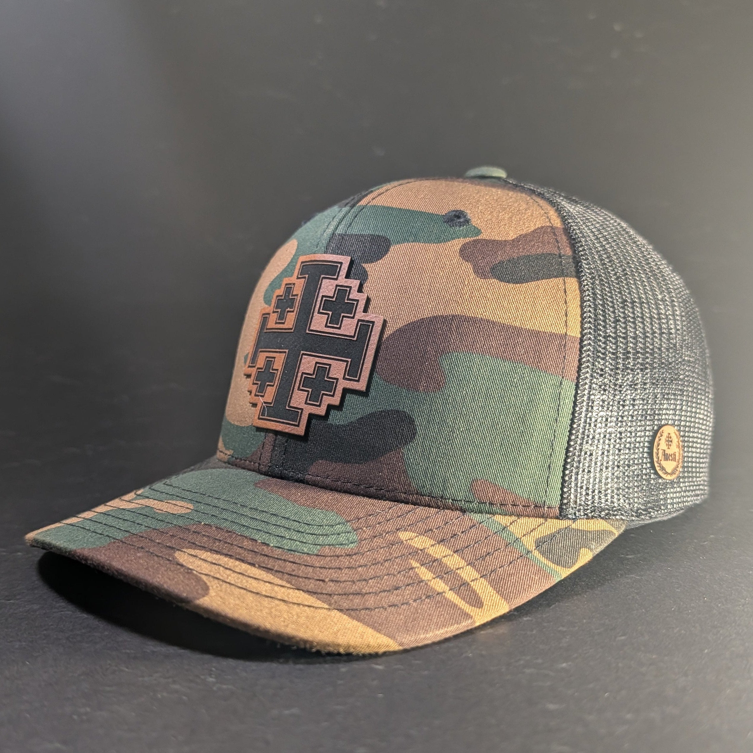 Jerusalem Cross Woodland curve bill snapback, three-quarter front view with tan leatherette cross patch on woodland camo